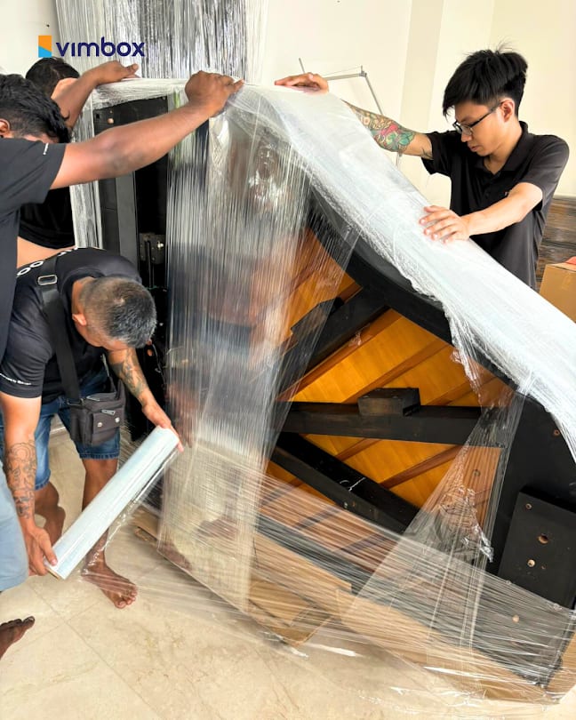 Vimbox crew wrapping a piano