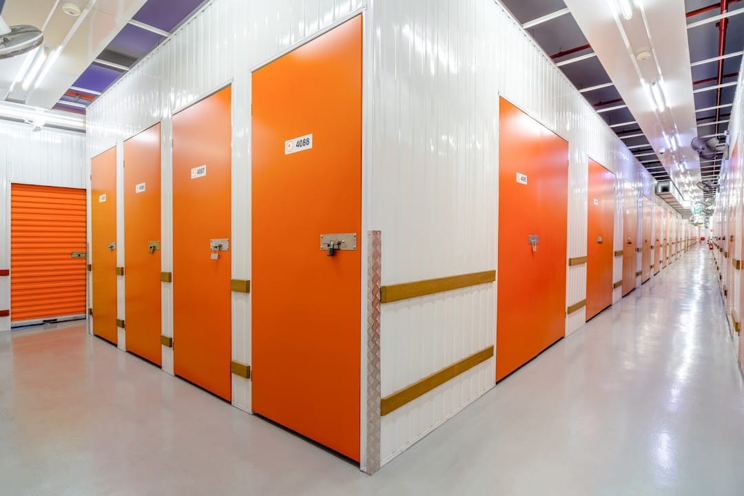 Corridor of orange StorHub storage units