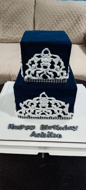 Navy tiered birthday cake with white lace detailing from Sooperlicious