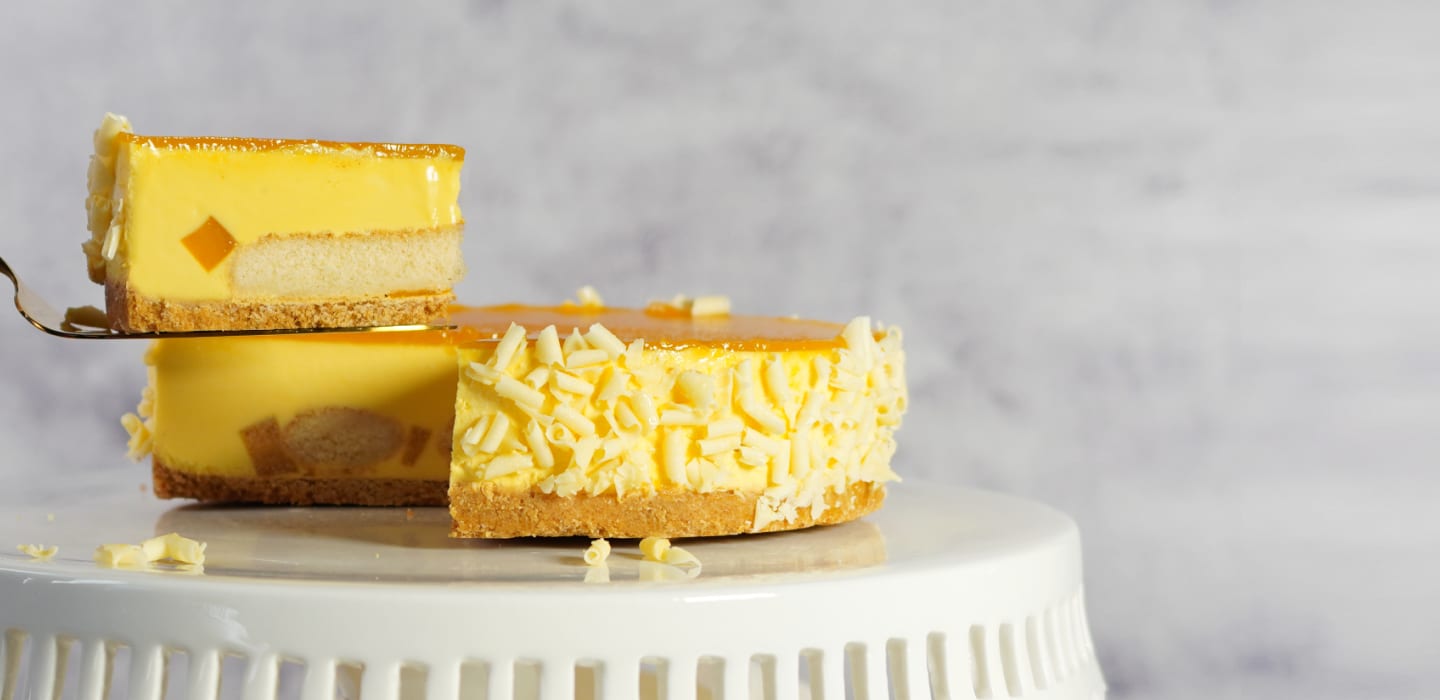 A slice lifted from a Cat & the Fiddle mango cheesecake