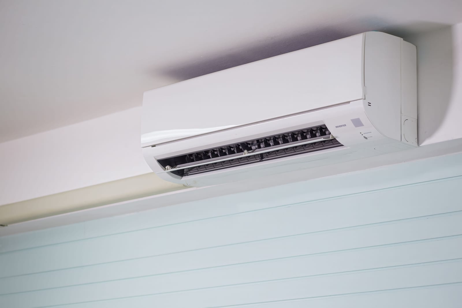 A wall-mounted split air-conditioner unit in a bright interior