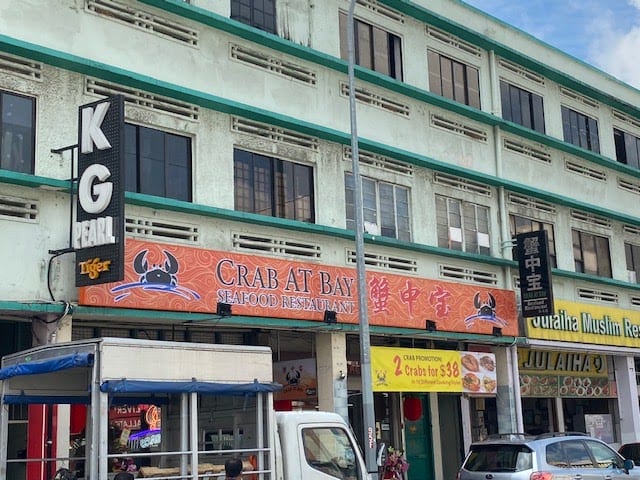 Crab at Bay Seafood storefront, MacPherson